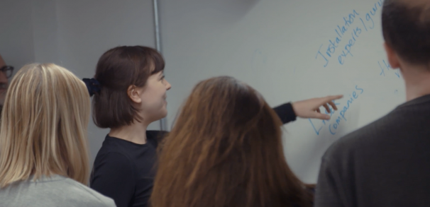Woman pointing at whiteboard during Clwstwr Ideas Lab
